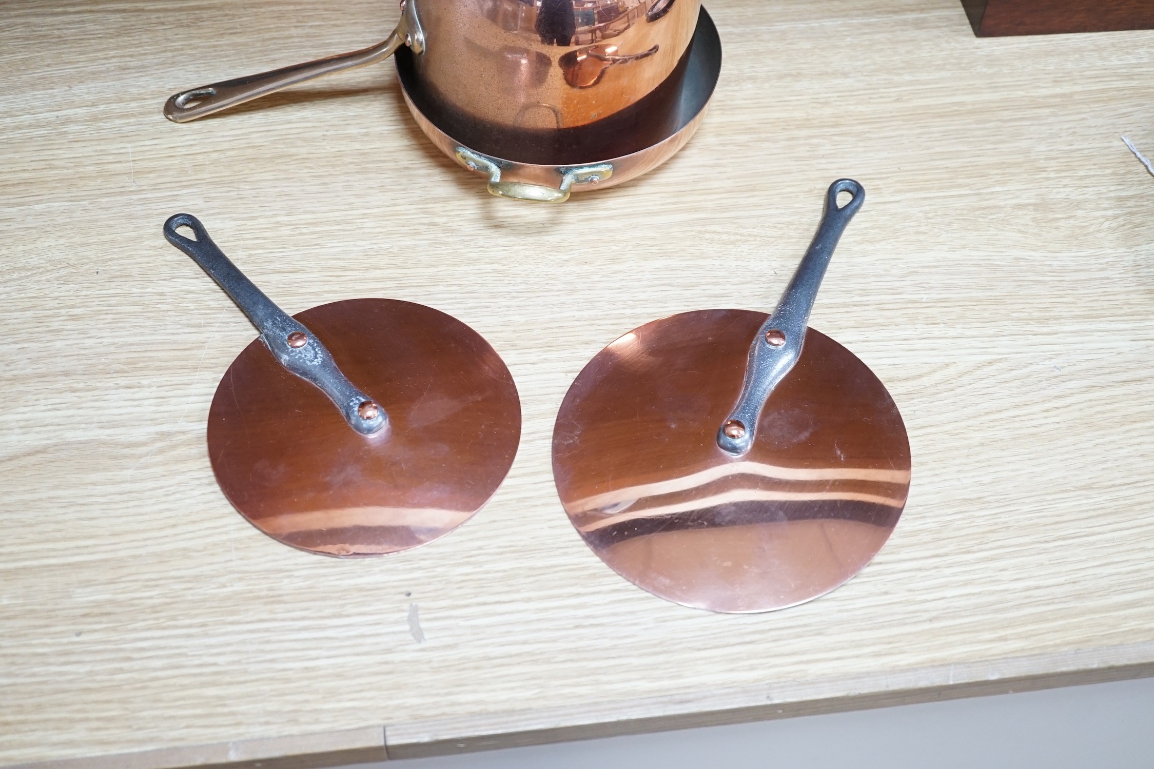 A quantity of copper pans including a zabaglione brass handled pan